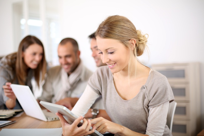 Young business girl working on tablet